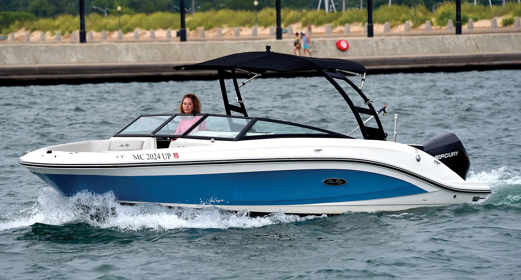 Dr. Stephanie Freels driving a blue boat