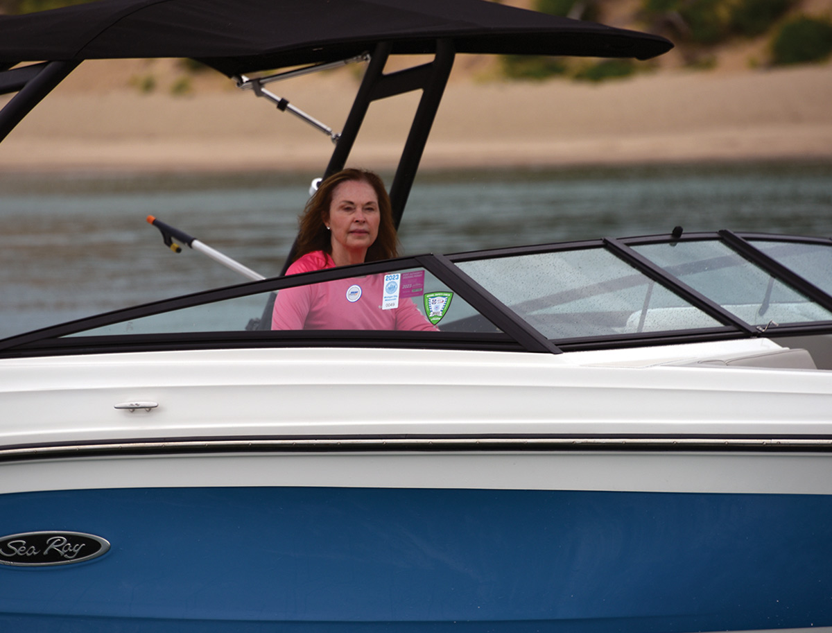 Dr. Stephanie Freels driving a blue boat