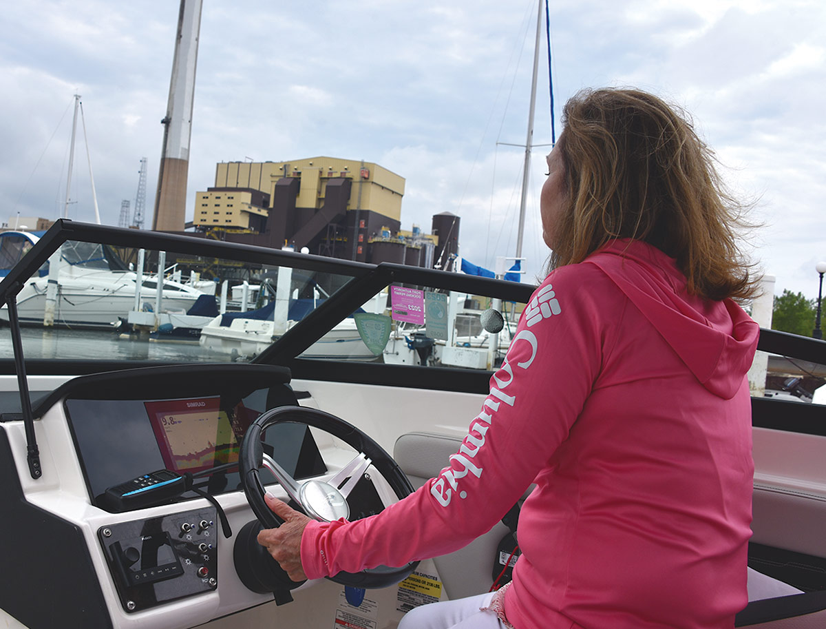 Dr. Stephanie Freels steering a boat