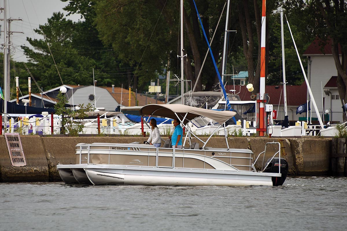 boat sailing alongside a dock