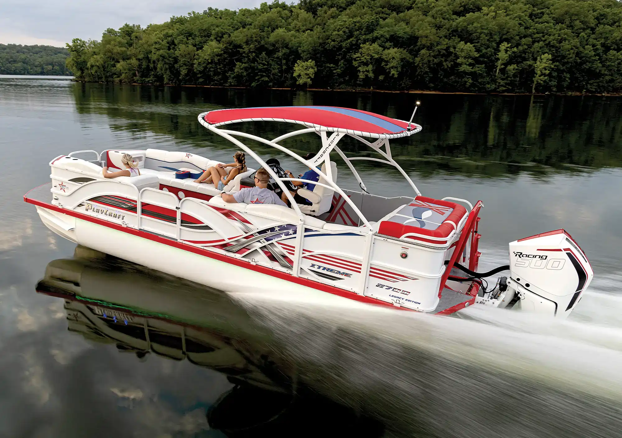 port side view of a Legacy Edition Playcraft Powertoon X-Treme racing across water as two couples relax on board