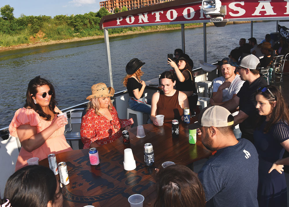 group of people having drinks on a pontoon boat
