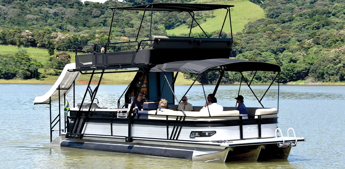 rear port side view of six passengers sitting on the lower level of a VCAT pontoon on water