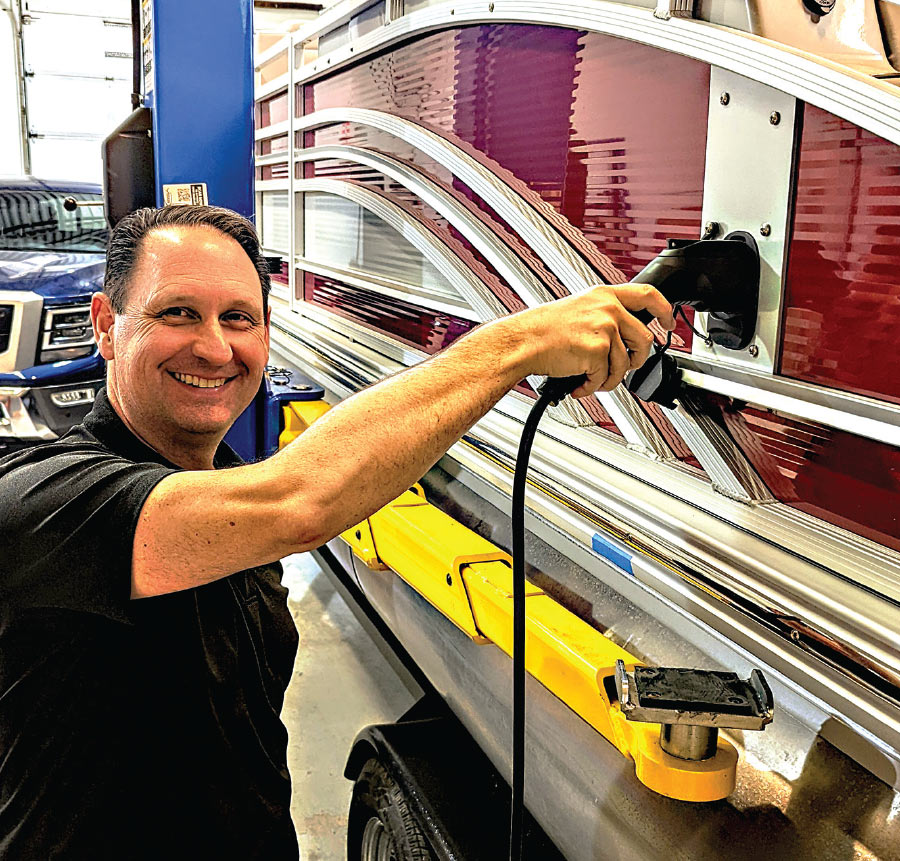 man plugging in Hercules Electric Marine boat