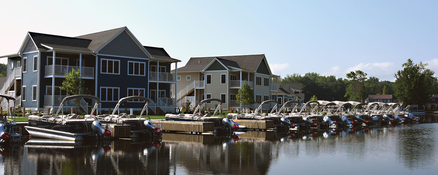 boats parked along docks near housing