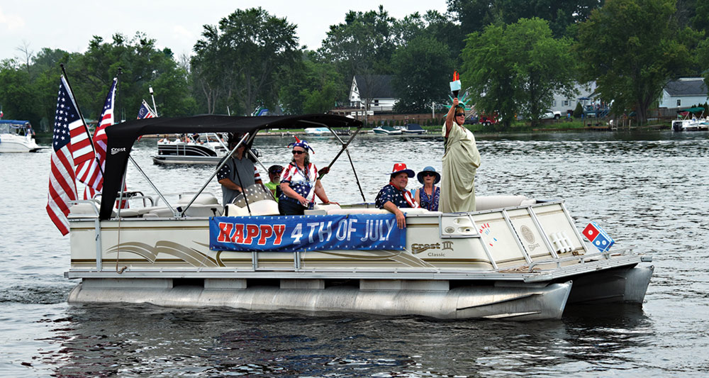 pontoon boat with Happy 4th of July banner