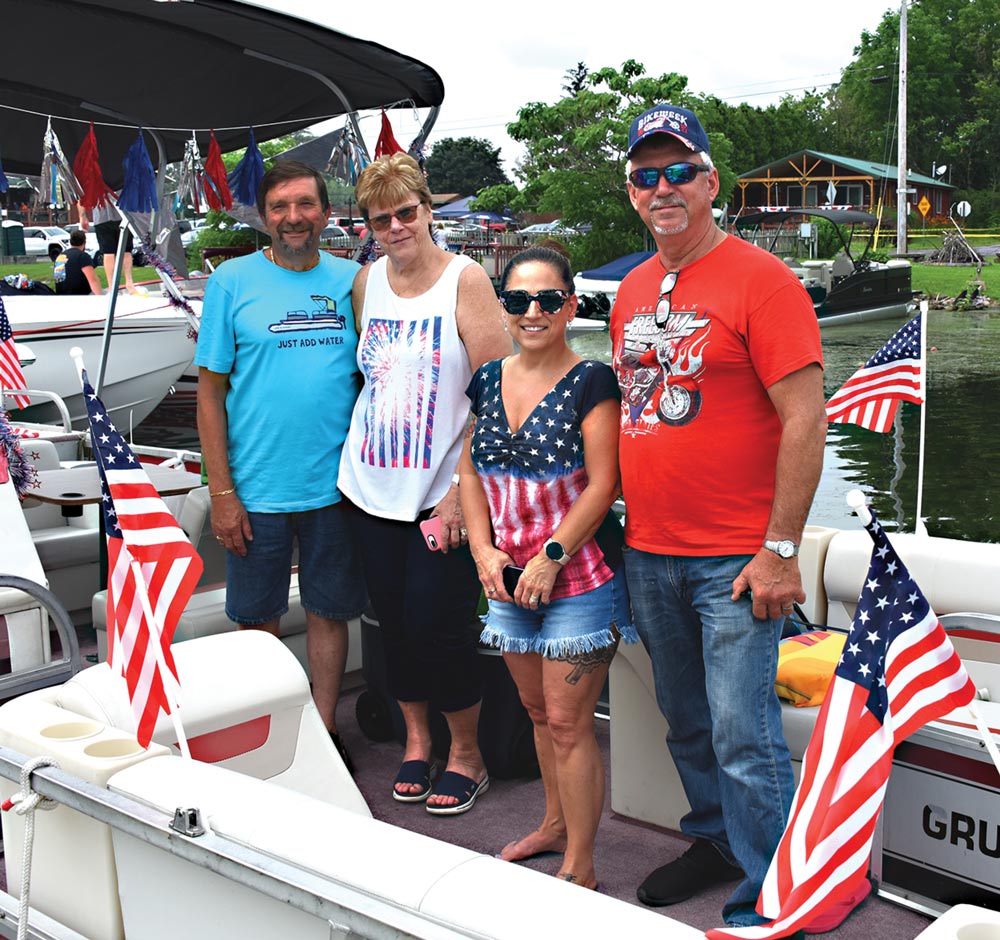 group of people posing together on a boat