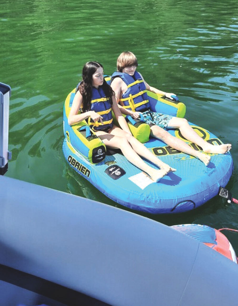 two kids floating on a raft