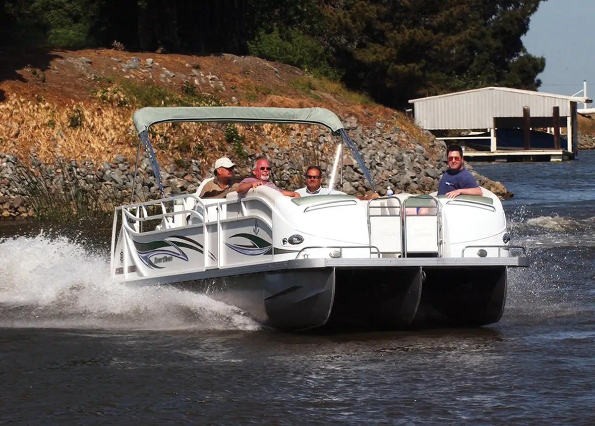 distant quarter view of four men riding a white pontoon in water