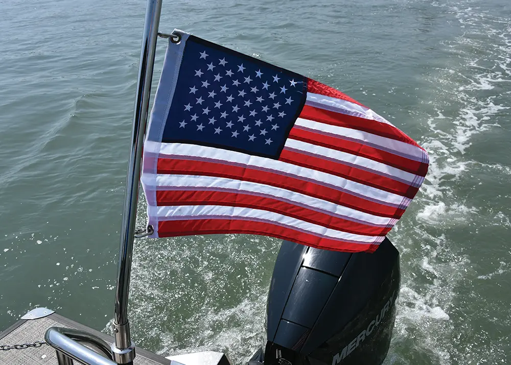 full view of the U.S. flag hoisted from the stern of the Barletta pontoon