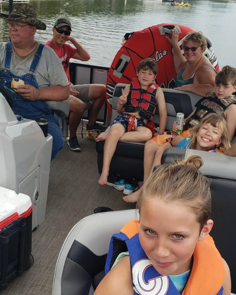 group of friends wear their life vests on board