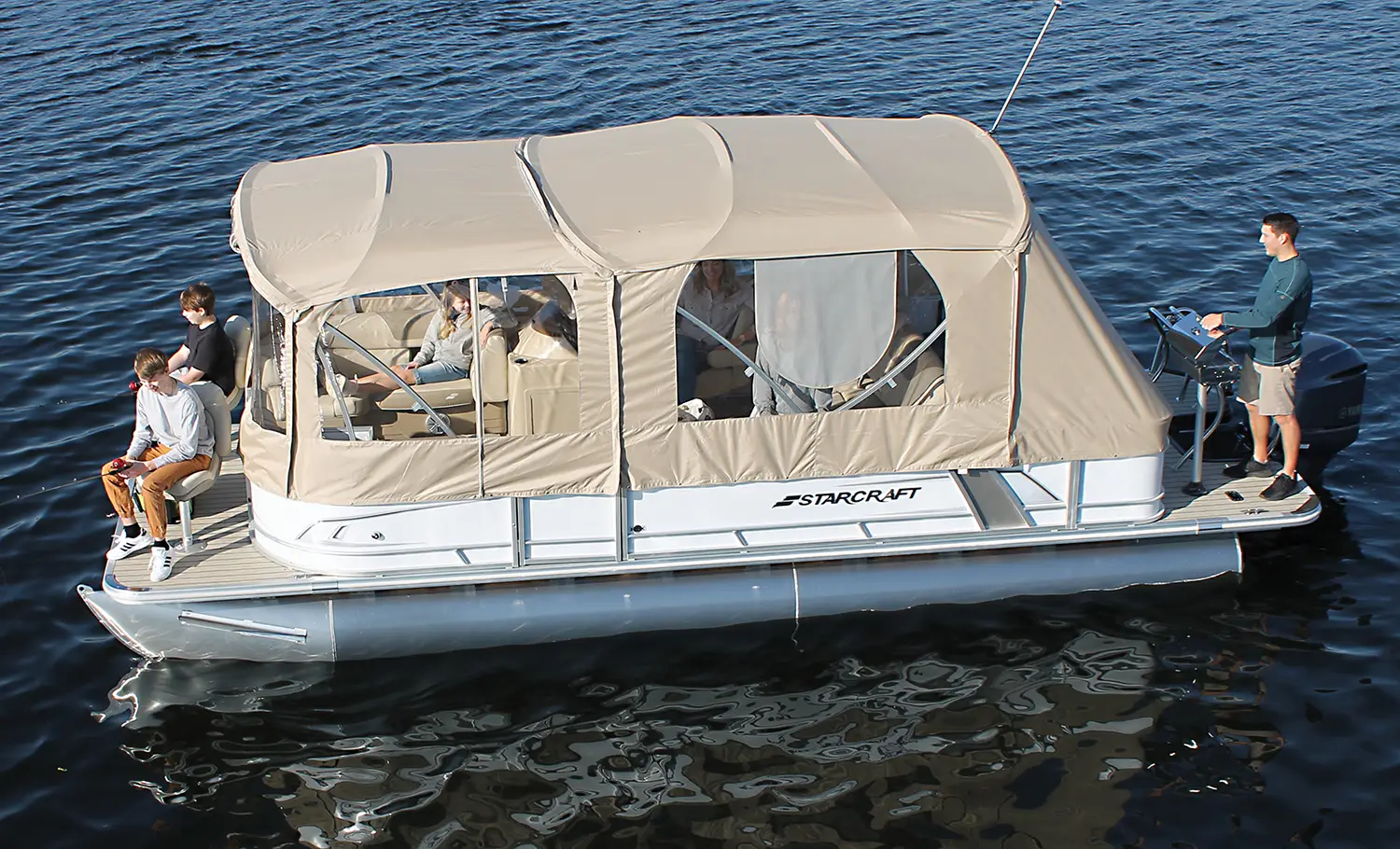 people fishing off of a covered boat