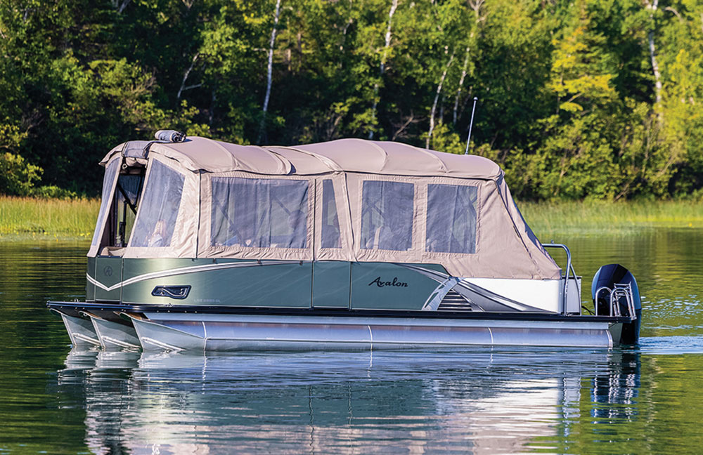 boat sitting on the water with a cover over the top