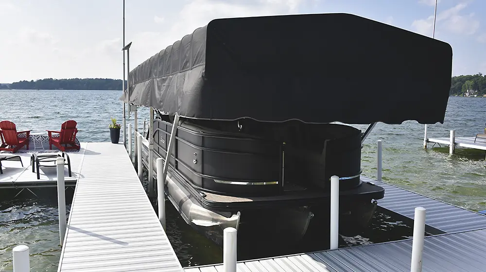 the Barletta pontoon docked at a small pier beneath a large black cover