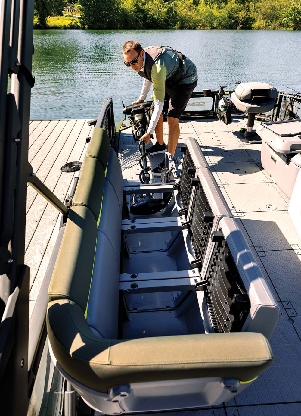 man using storage compartments on a boat