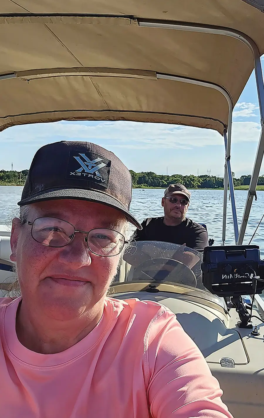 man and woman taking a selfie on a pontoon