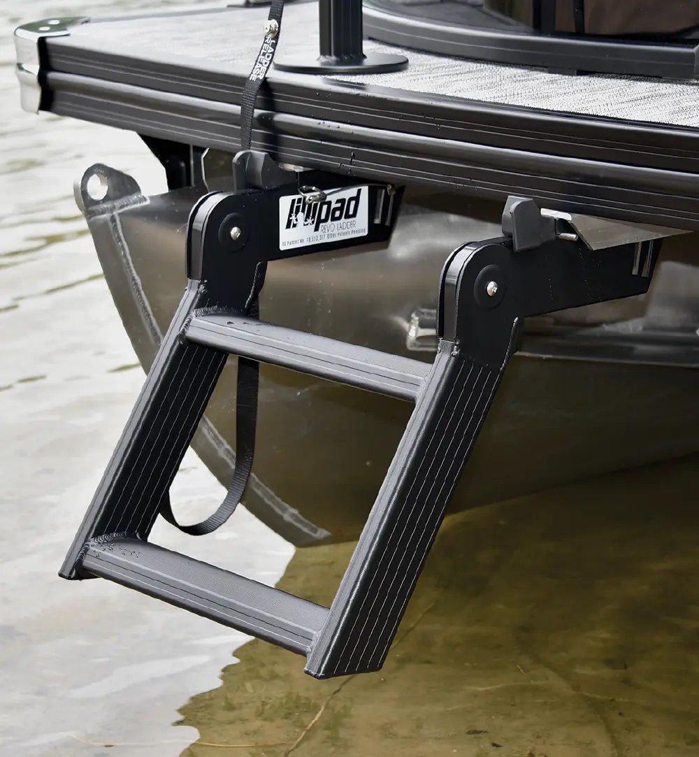 Close-up outdoor portrait photograph of the LilliPad Marine Revo Step Boarding Ladder product attached/installed to the back of a pontoon motorboat vehicle within proximity of the water