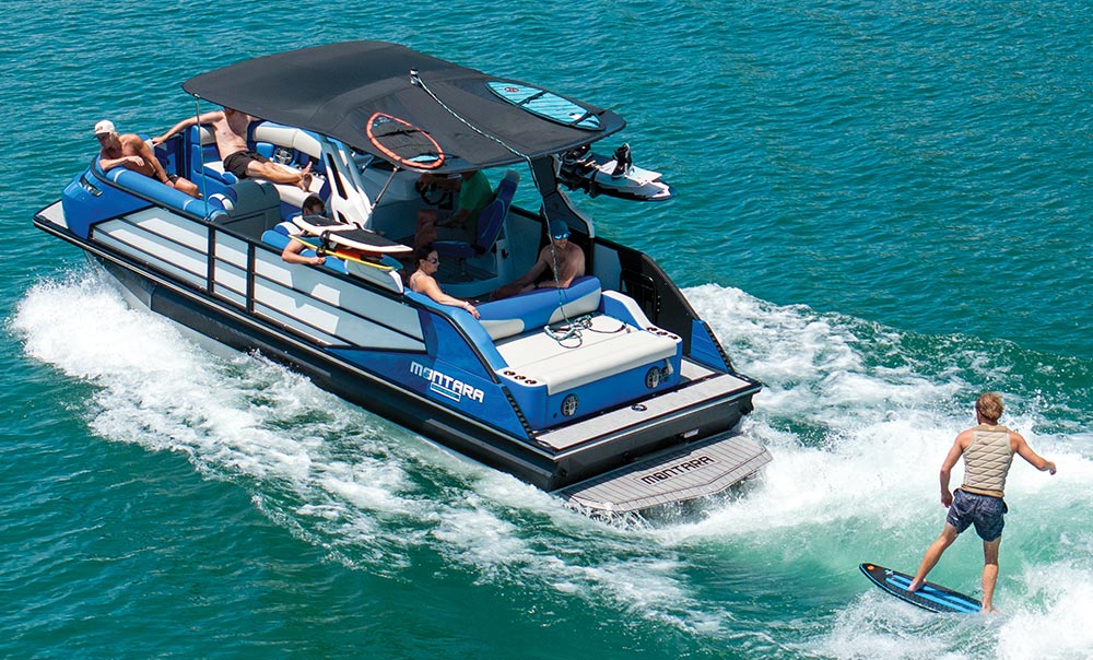 aerial view of a blue and white Montara 2.0 25 pontoon in the water