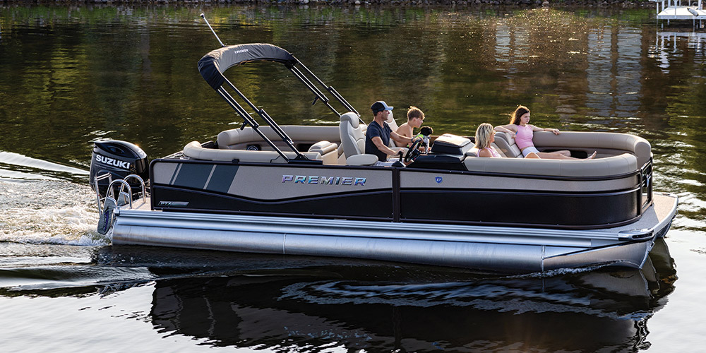 beige and black Premier 230 Sunsation pontoon in the water