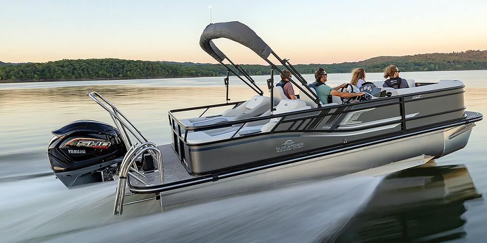 white and silver SunCatcher Select 322 SS pontoon in the water