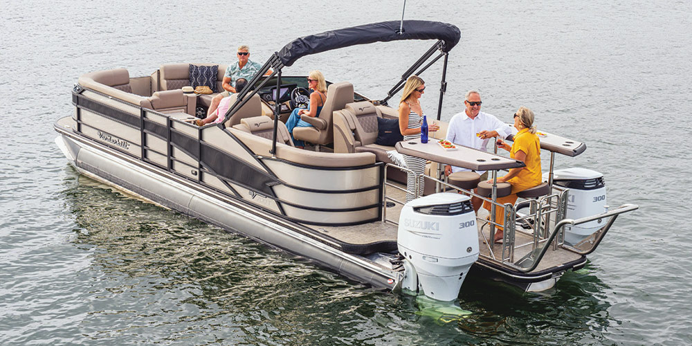 beige and brown Vanderbilt V700T pontoon in the water