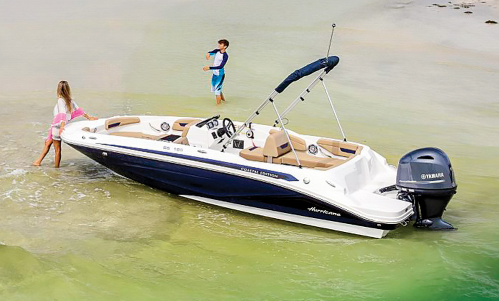 black and white Hurricane SunDeck Sport 185 boat sitting idly in the water