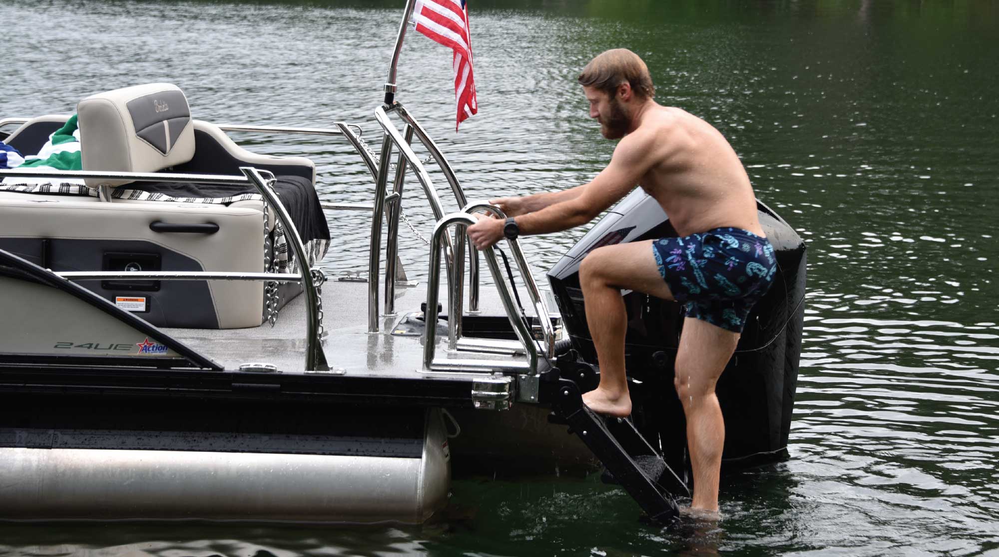 man climbing up pontoon rear ladder and steps