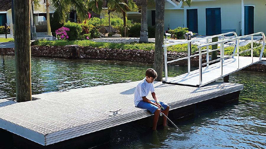 young boy sitting on coastal rhino dock