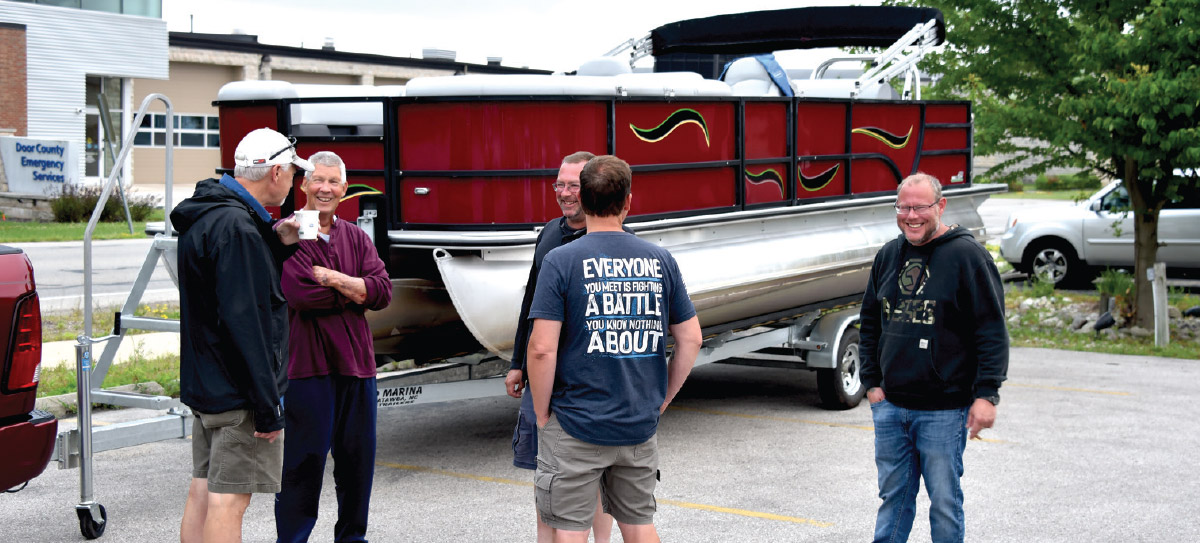 men chatting and standing around Bentley Legacy 223 Navigator