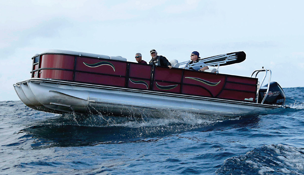 three men on Bentley Legacy 223 Navigator in the water