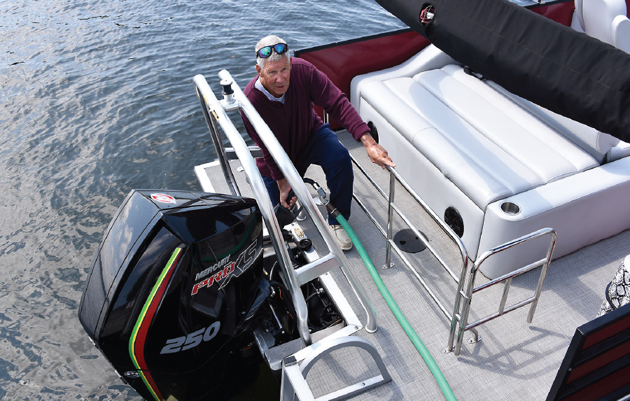 man on one knee on rear of pontoon