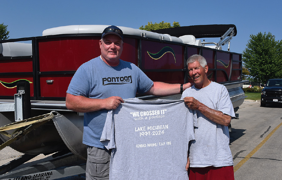 PDB Editor Brady Kay holding up a shirt with Goofy Sohm
