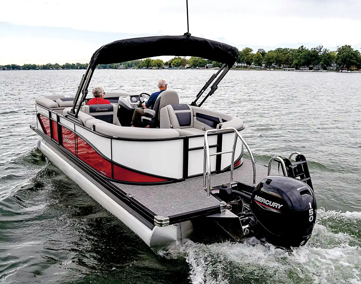 3/4 view of a red and white MY2025 Barletta Cabrio pontoon in the water