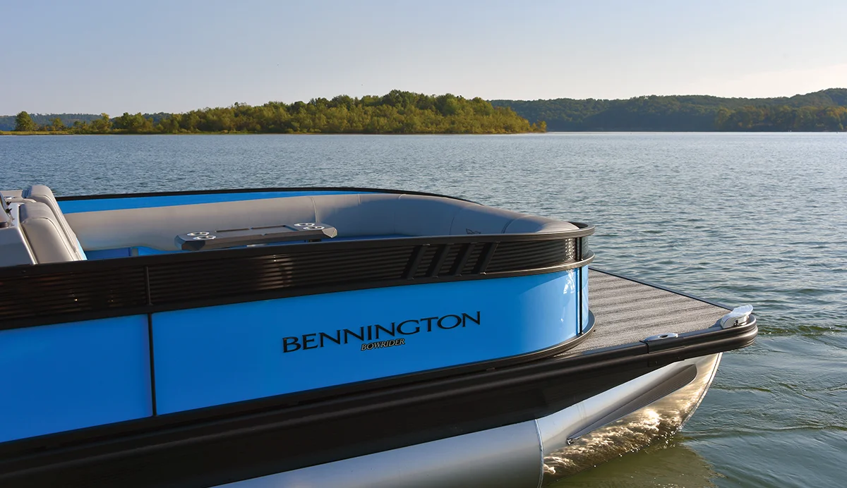 close up of a blue and black Bennington pontoon in the water