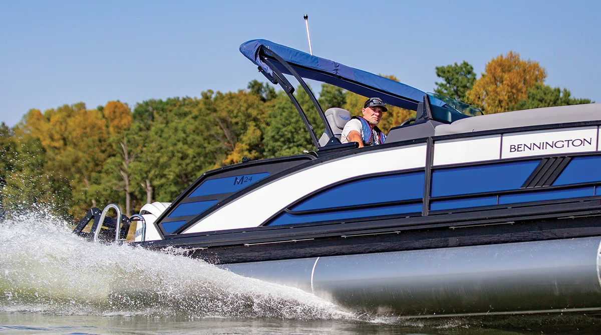 blue and black Bennington pontoon cruising through the water