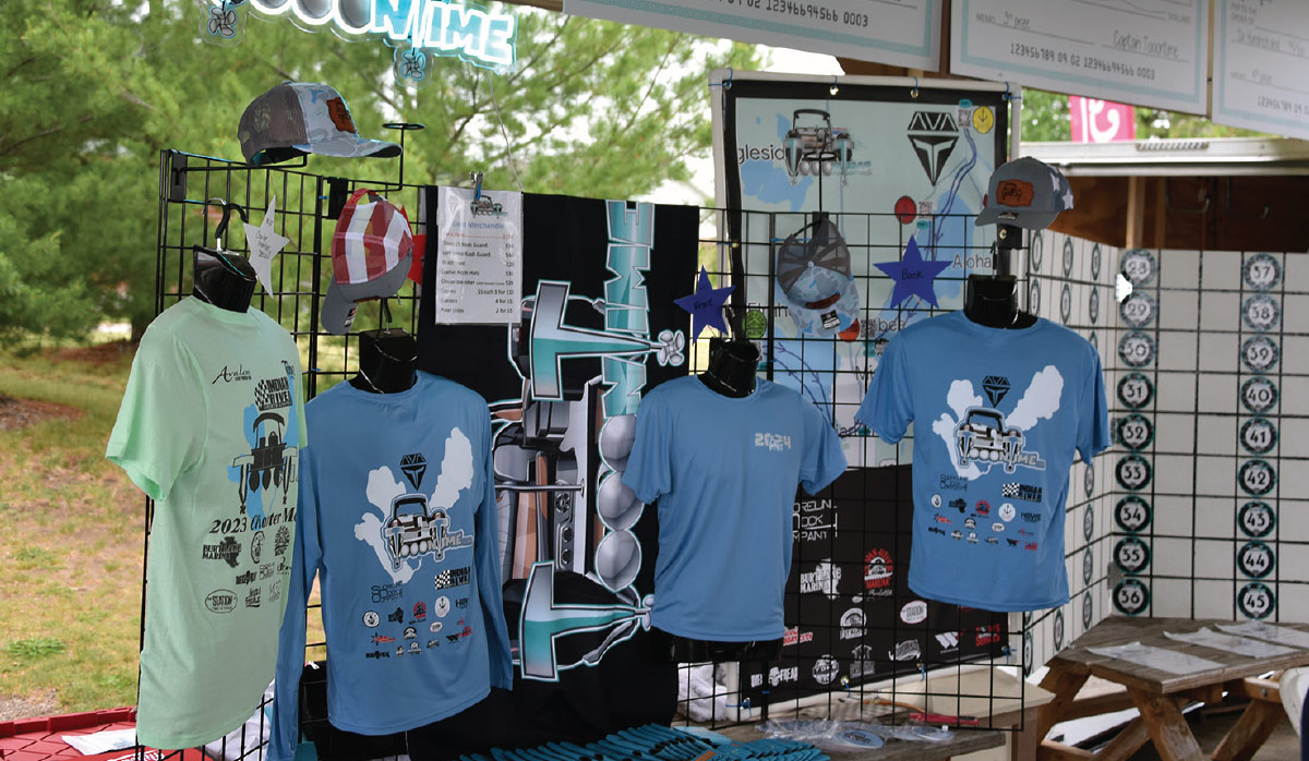 booth display wall with shirts, hats, and more merch
