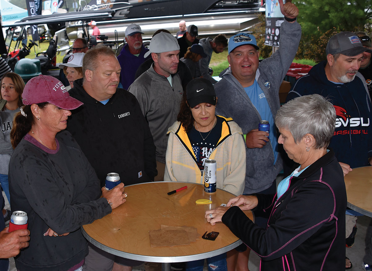 table of two women and one man in front of card dealer at table