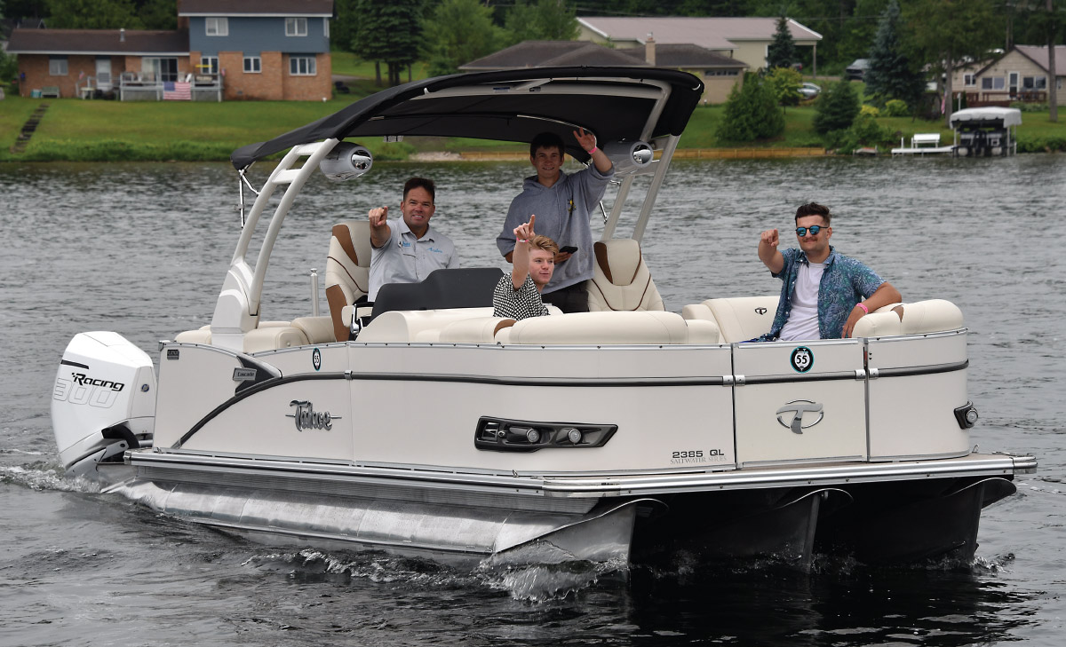 4 men on pontoon boat on water