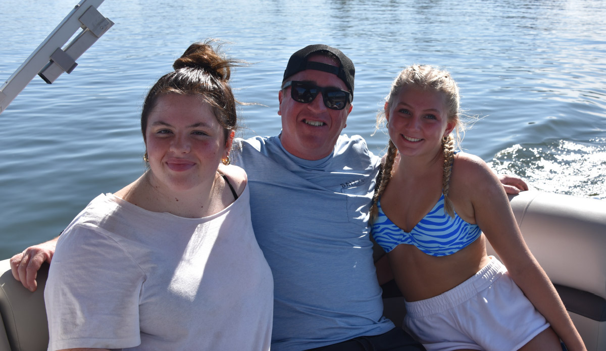 group photo of Lilly Espey, Tyler Espey and Ava Varla sitting on boat
