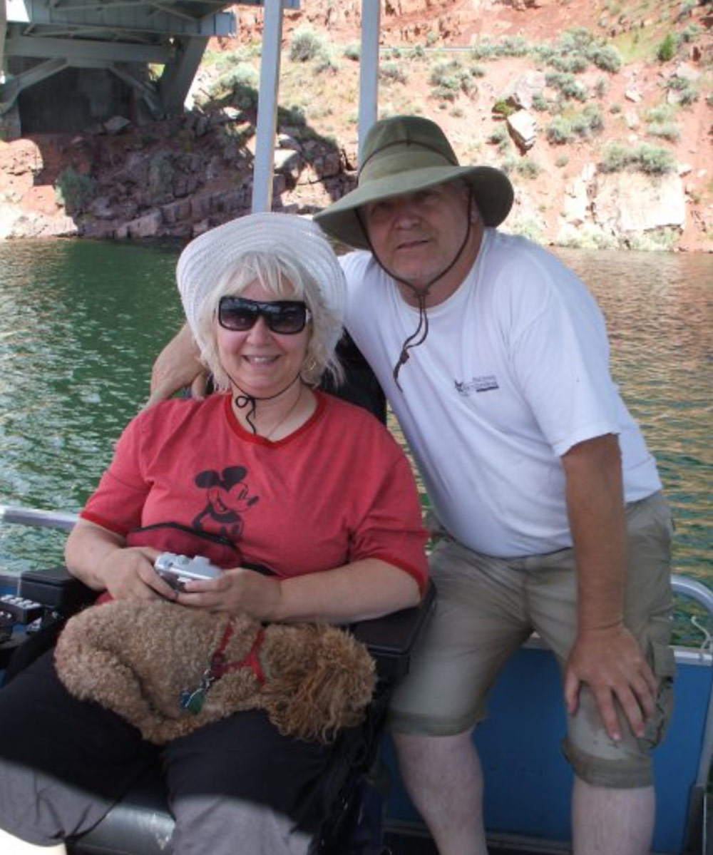 man and woman sitting on boat together smiling and smiling for a photo