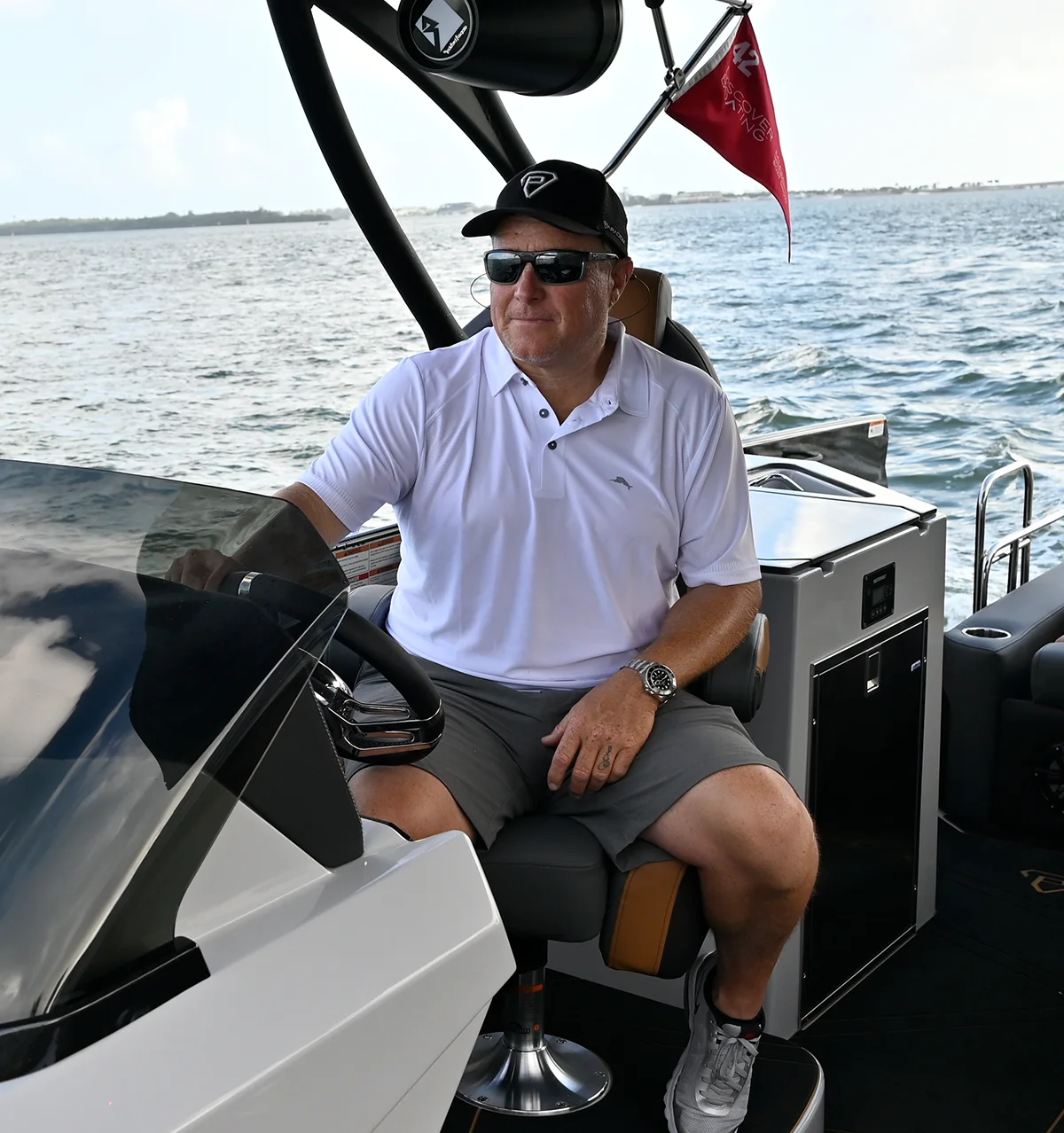 Scott Buchanan sitting at the captain's chair and steering a pontoon