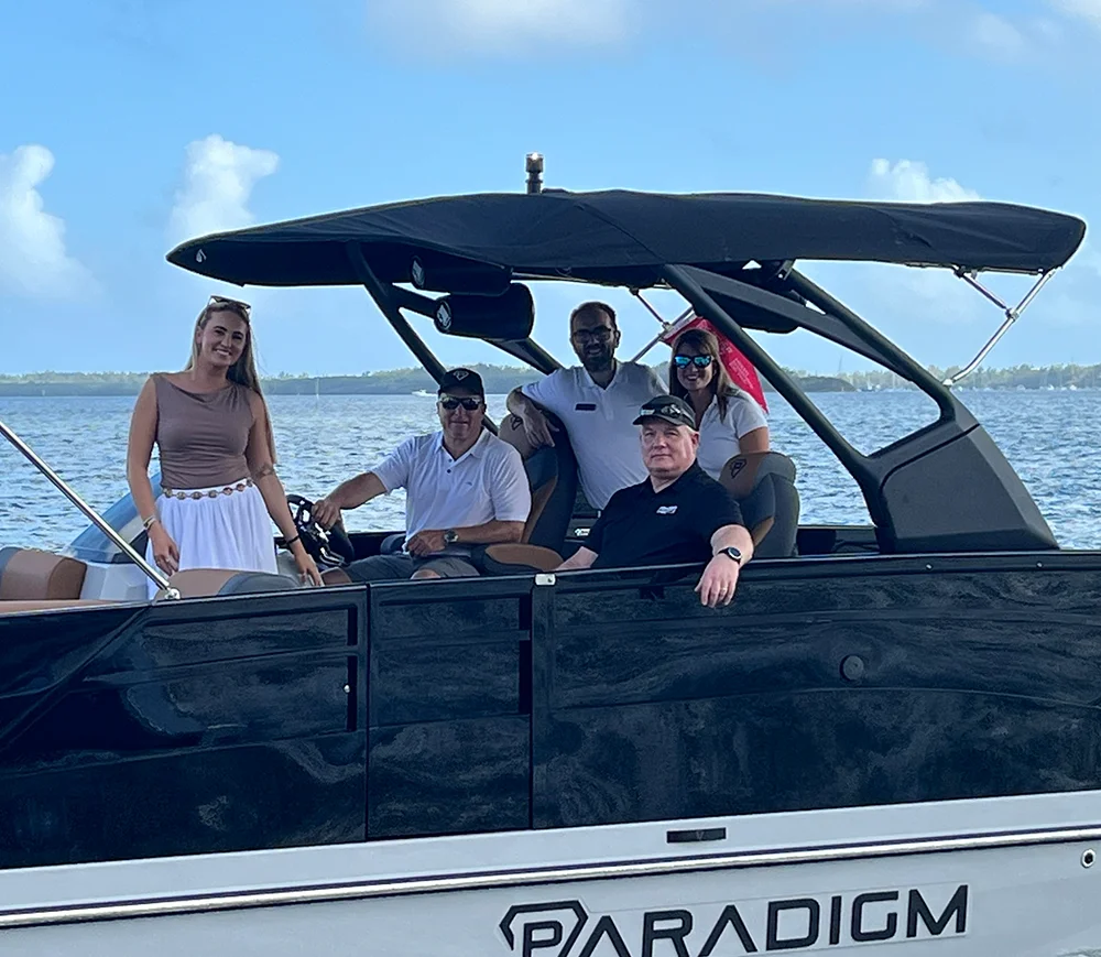 group of people smiling inside a Paradigm pontoon