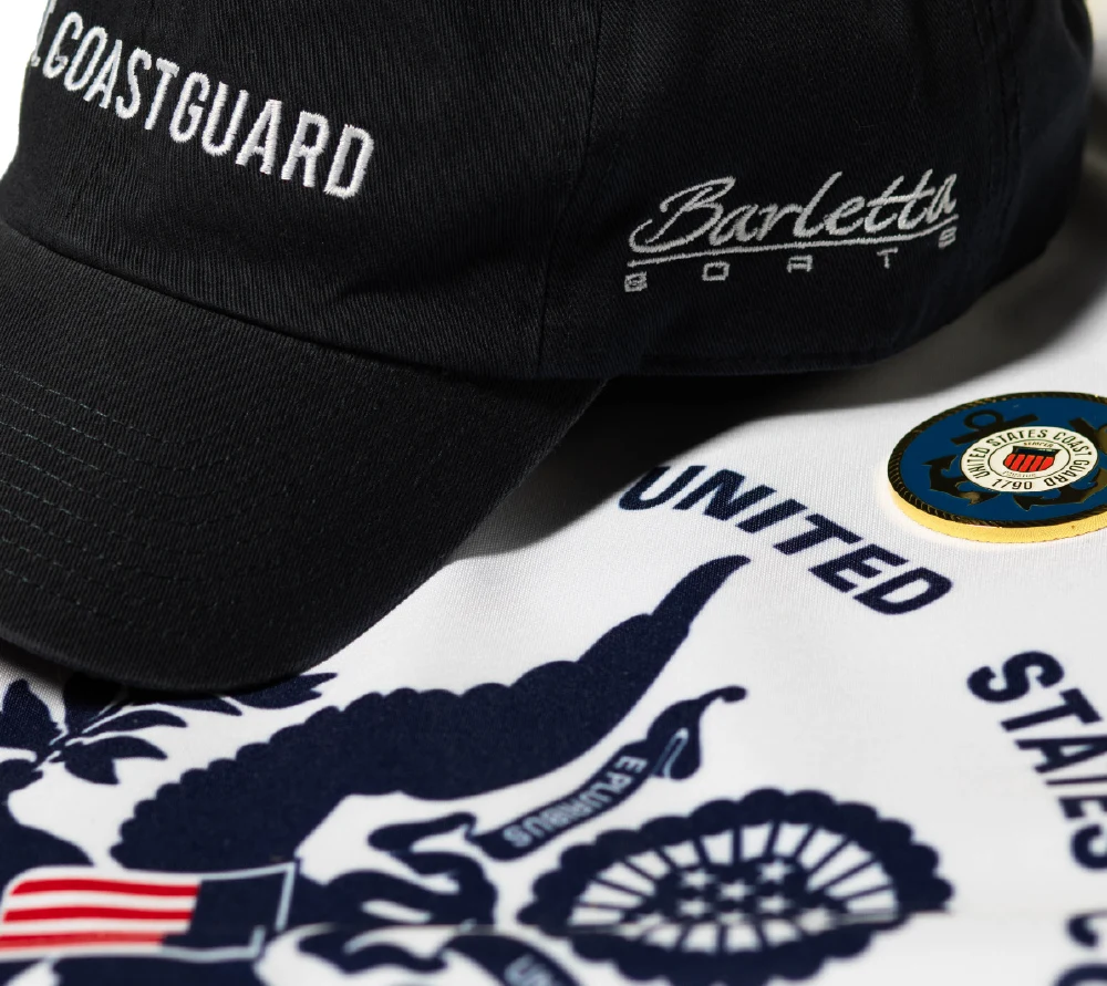 close up of a Barletta Boats hat and a United States coast guard flag