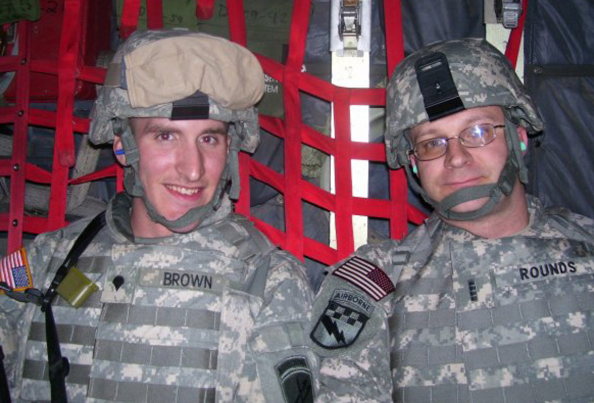 Robert Rounds in uniform smiling for a photo with another man in uniform 