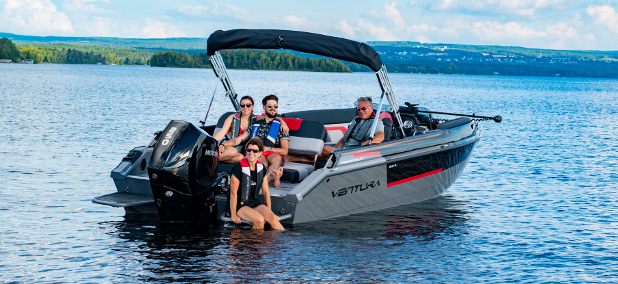 family seated in anchored Ventura pontoon on lake