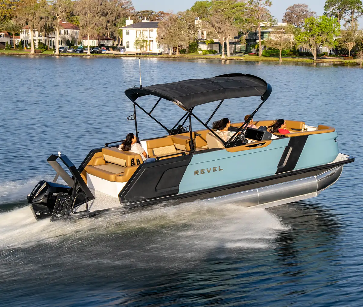 starboard side view of a group of woman sailing on a pale blue and black Revel pontoon