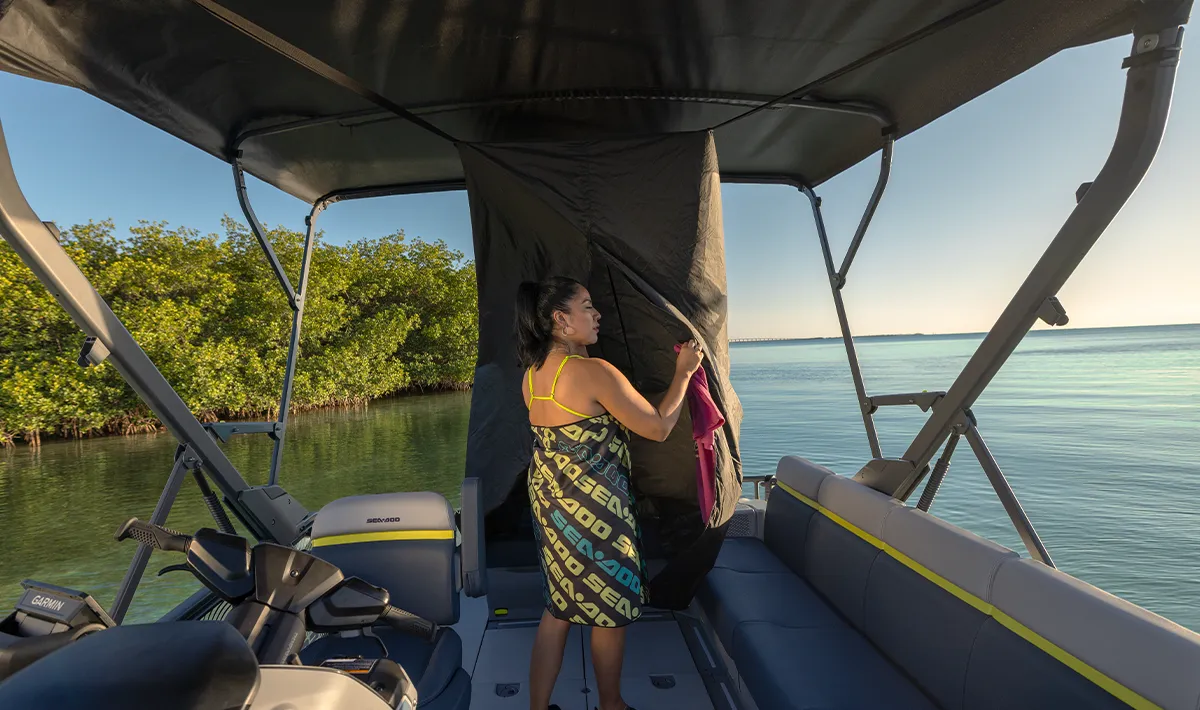 wide view of a woman standing in the center of a Sea-Doo pontoon