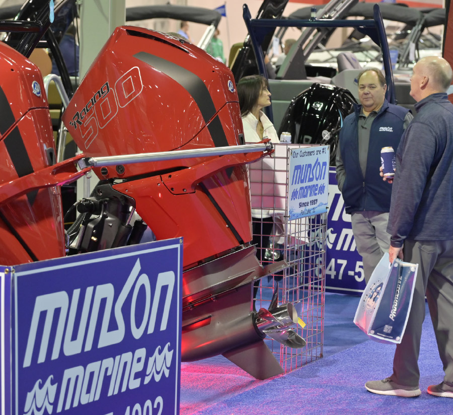 engine on display at boat show with people standing near it
