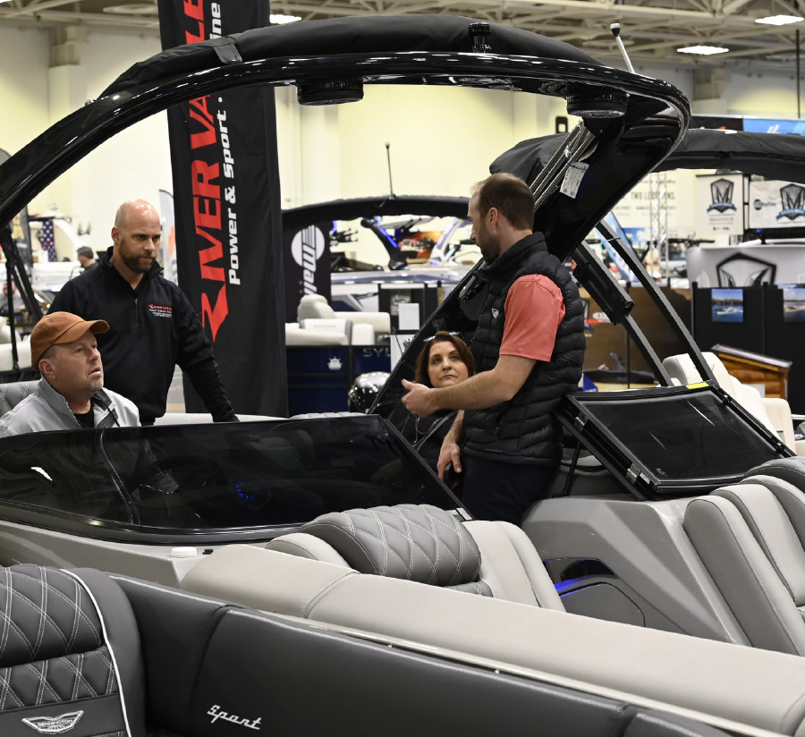 three men and a woman in pontoon on display