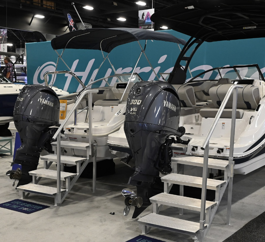 rear of pontoon with engines and lowered stairs displayed